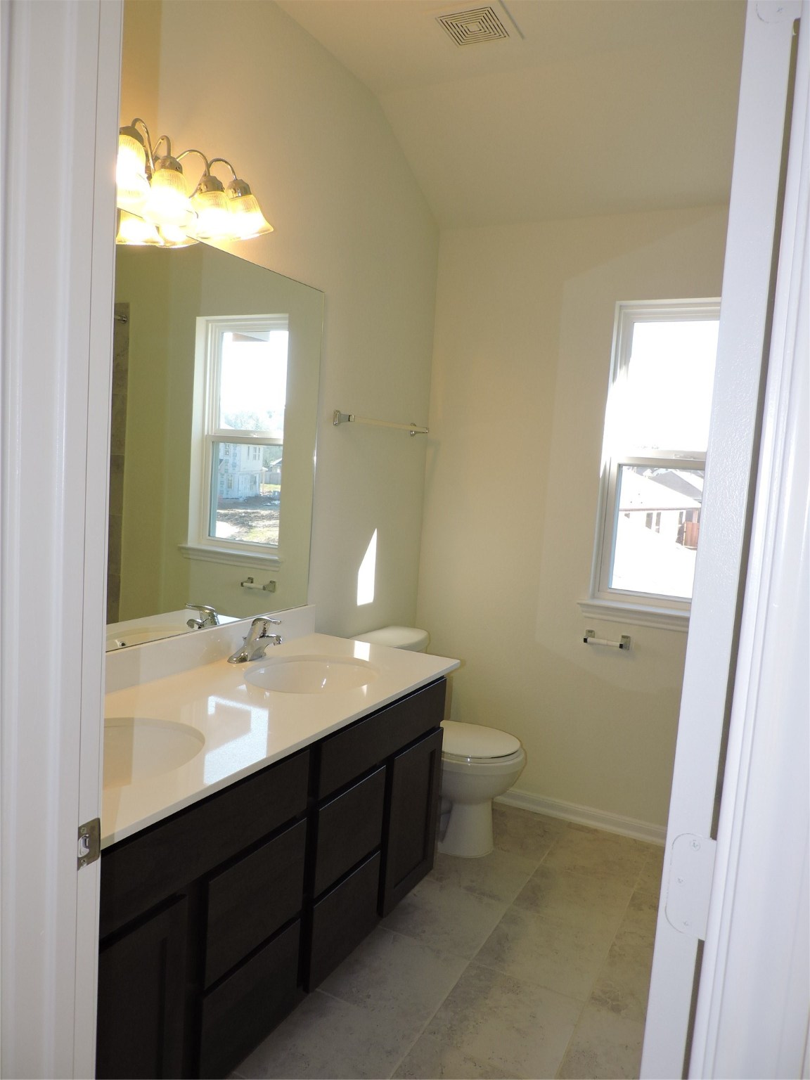 1122 Epworth Ct. Conroe, TX 77304 - Photo 30 of 35 a bathroom with a double vanity sink toilet and a mirror