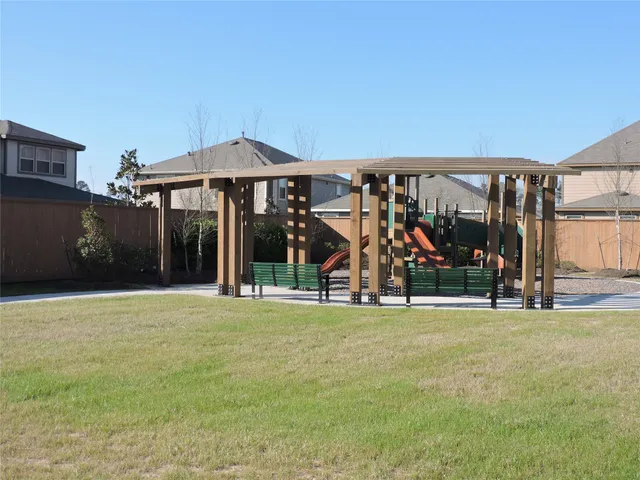 a view of a house with floor to ceiling windows and yard