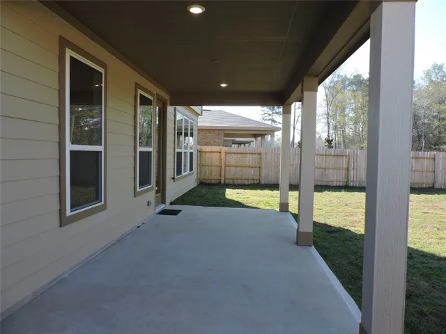 a view of a porch with chairs and backyard
