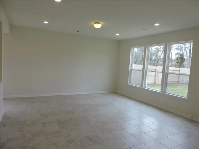 an empty room with windows and entrance