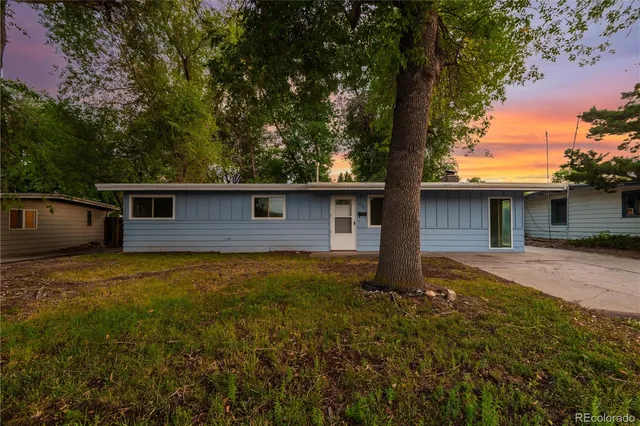 a front view of house with yard and trees