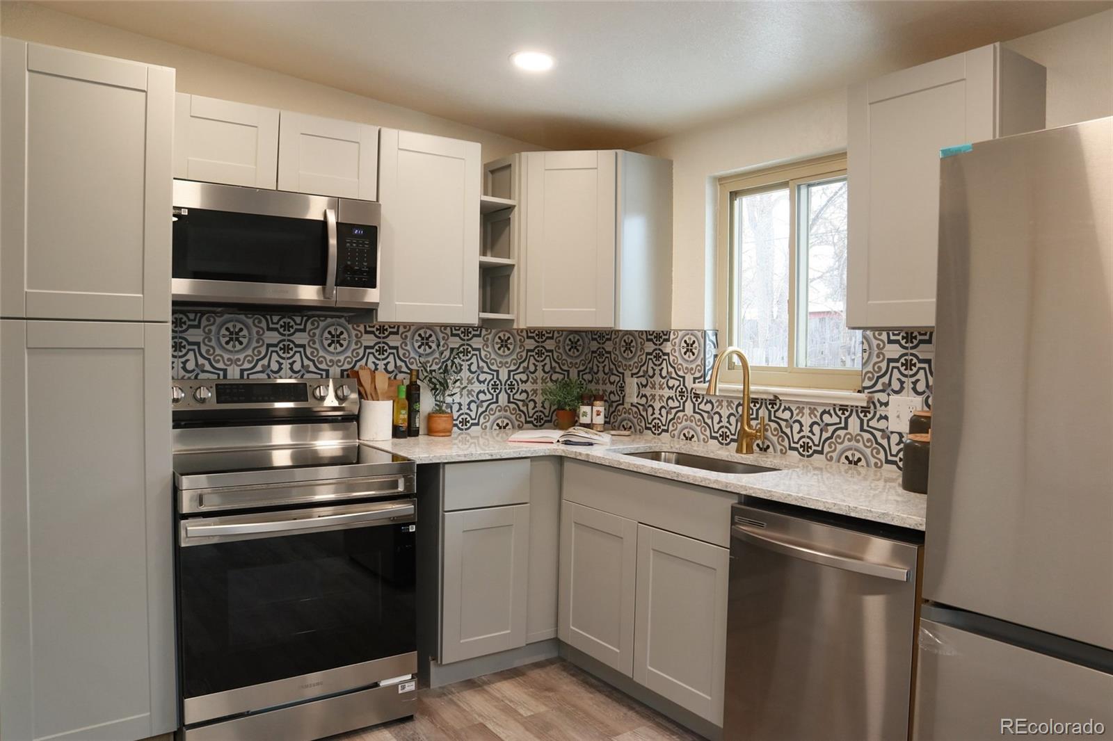635 West Prospect Road Fort Collins, CO 80526 - Photo 3 of 17 a kitchen with a sink stove and microwave