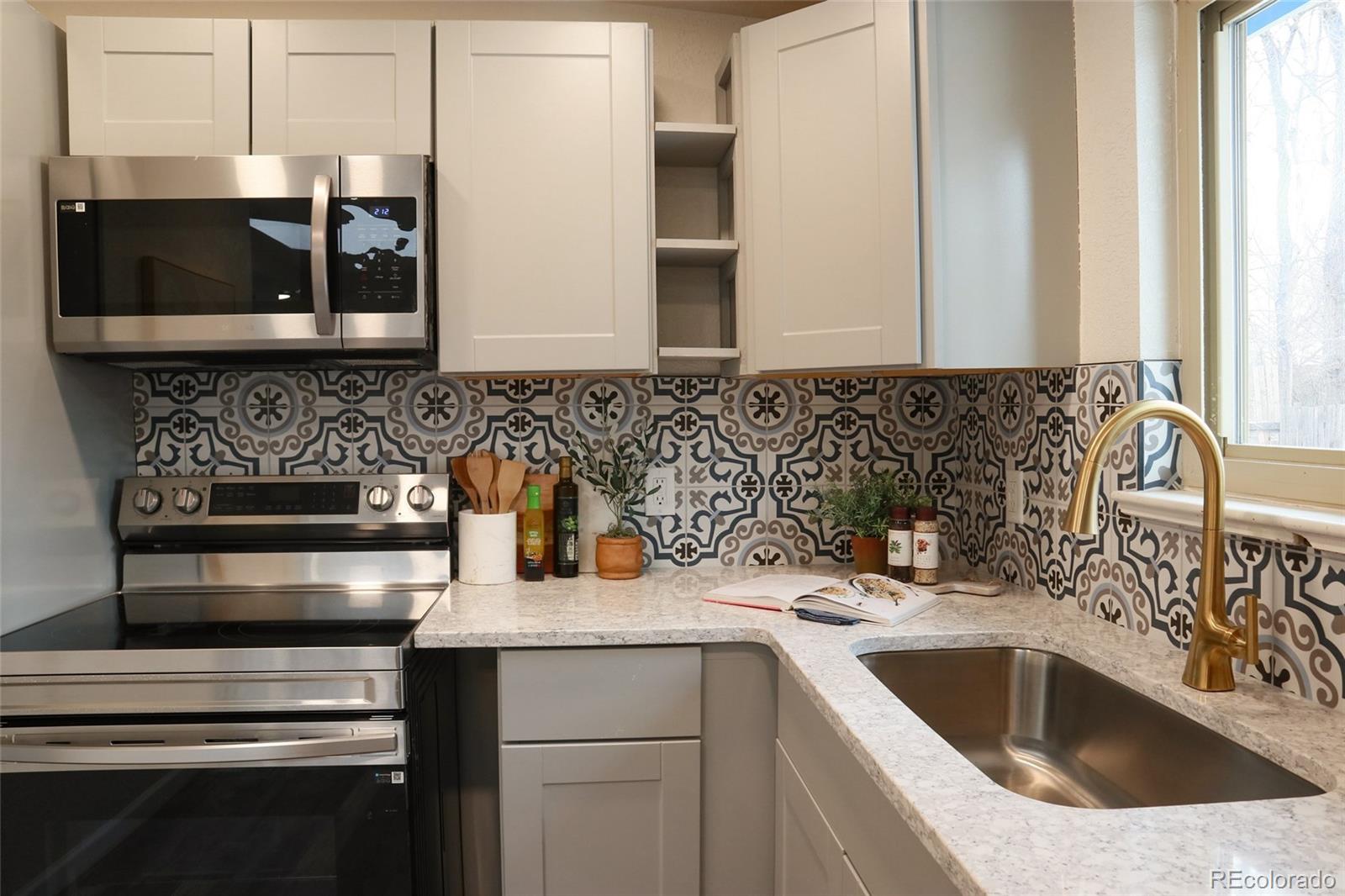 635 West Prospect Road Fort Collins, CO 80526 - Photo 6 of 17 a kitchen with a sink and a stove