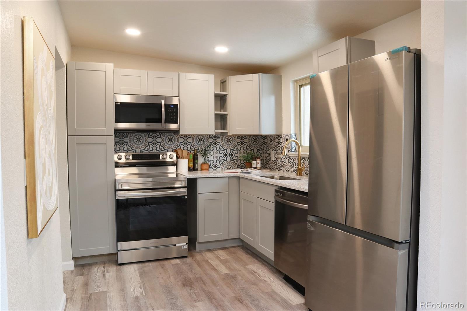 635 West Prospect Road Fort Collins, CO 80526 - Photo 10 of 17 a kitchen with stainless steel appliances a refrigerator sink and microwave
