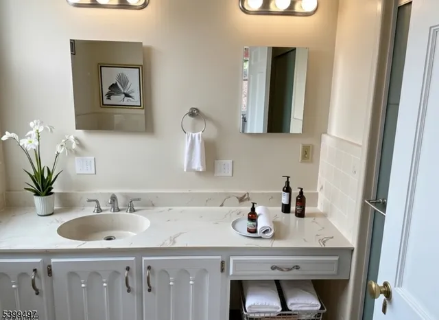 a bathroom with a sink and a mirror