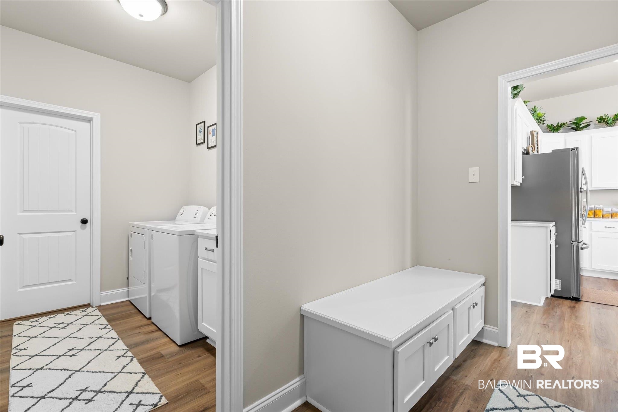 1116 Stella Road Foley, AL 36535 - Photo 22 of 29 Washroom featuring hardwood / wood-style floors, cabinets, and independent washer and dryer