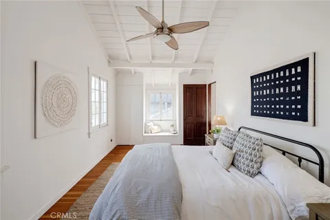 a bedroom with a bed dresser and a window