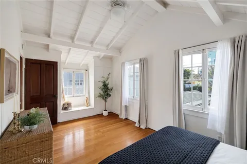 a view of a bedroom with furniture and windows