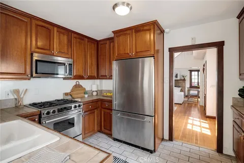a kitchen with stainless steel appliances granite countertop a refrigerator stove and microwave