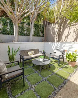 a view of a chairs and table in backyard