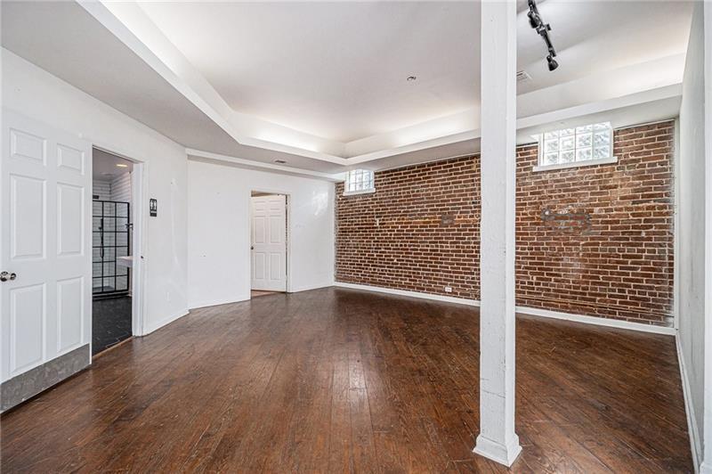 1112 Delaware Avenue Southeast Atlanta, GA 30316 - Photo 13 of 30 a view of an empty room with wooden floor and a window