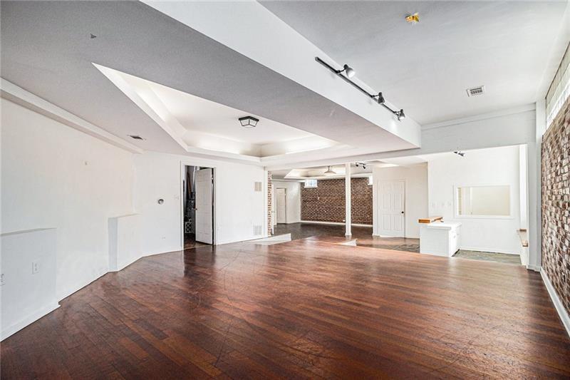 1112 Delaware Avenue Southeast Atlanta, GA 30316 - Photo 6 of 30 an empty room with wooden floor and windows