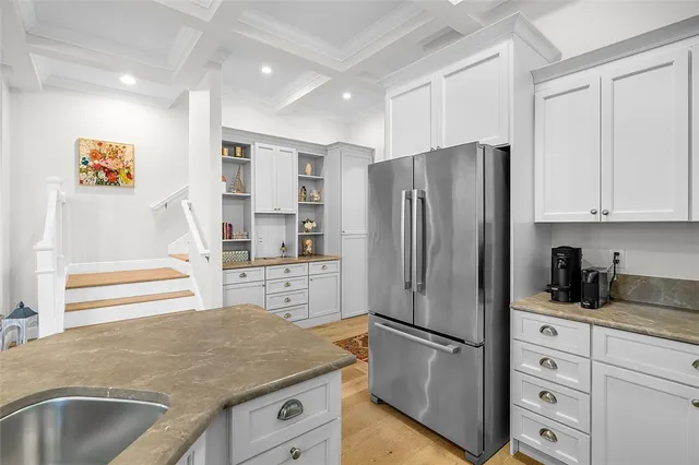 a kitchen with stainless steel appliances granite countertop a refrigerator and a sink