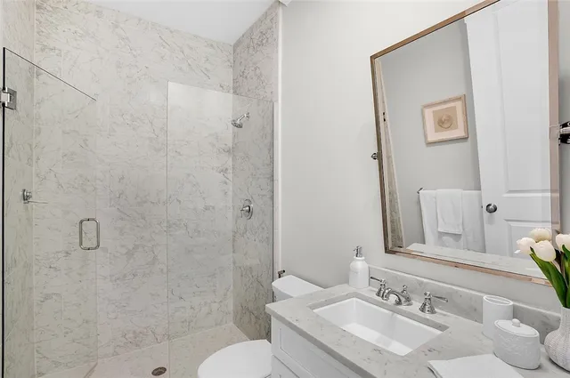 a bathroom with a sink toilet and shower