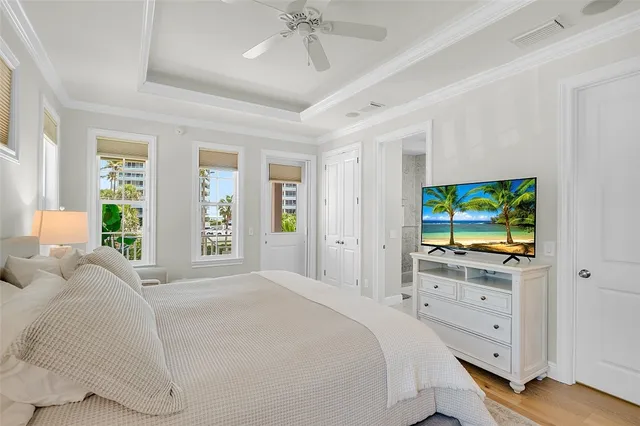 a bedroom with a bed and a flat tv screen on dresser