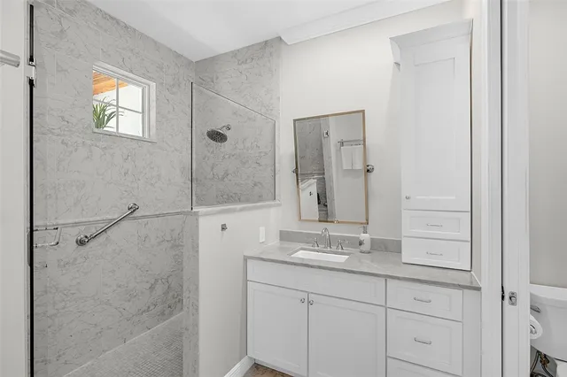 a bathroom with a shower sink and mirror
