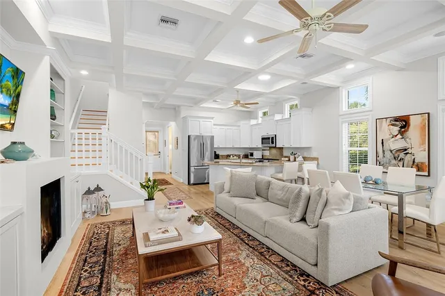 a living room with furniture kitchen view and a fireplace