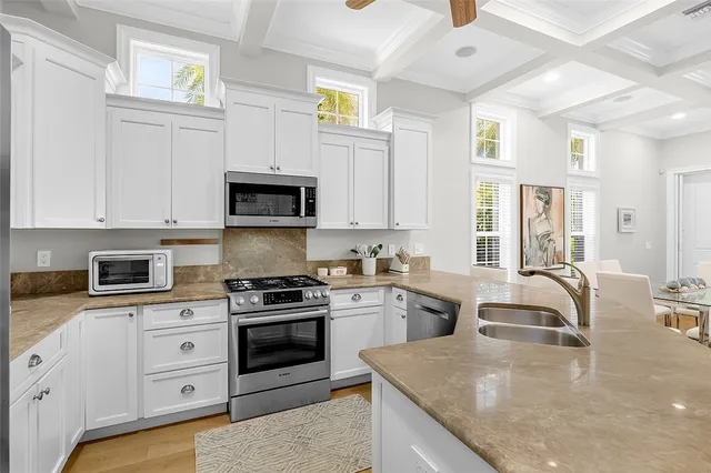 a kitchen with granite countertop a stove and a sink