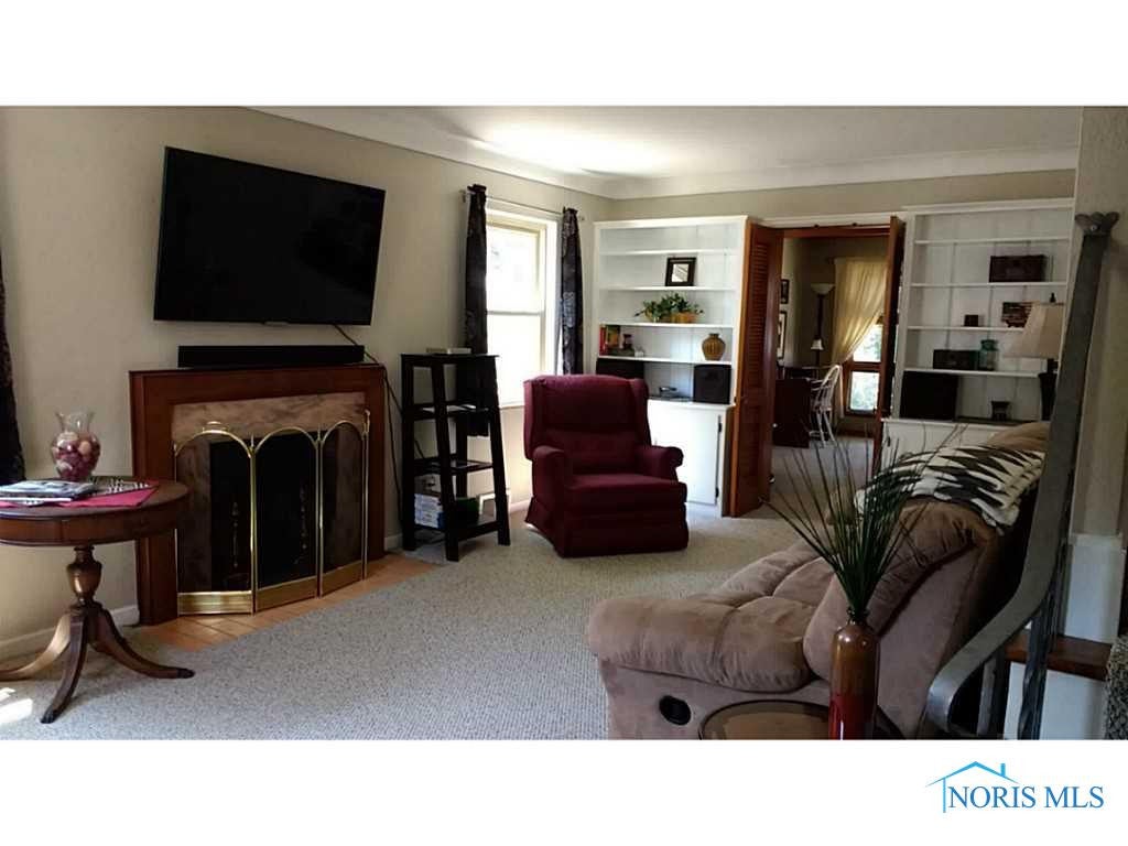 Living Room. To the left from entry, built-ins and fireplace.