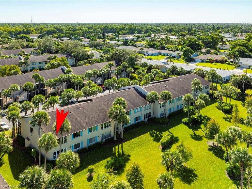 an aerial view of residential houses with outdoor space and swimming pool