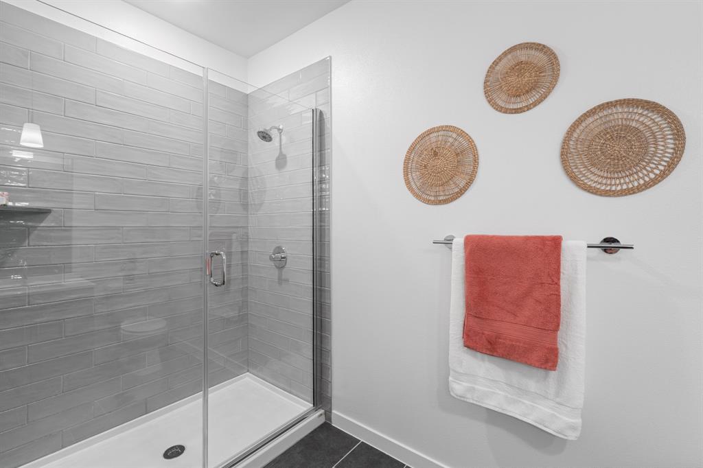 4801 Springdale Road, Unit 2010 Austin, TX 78723 - Photo 12 of 28 Bathroom with a shower stall and dark tile patterned floors