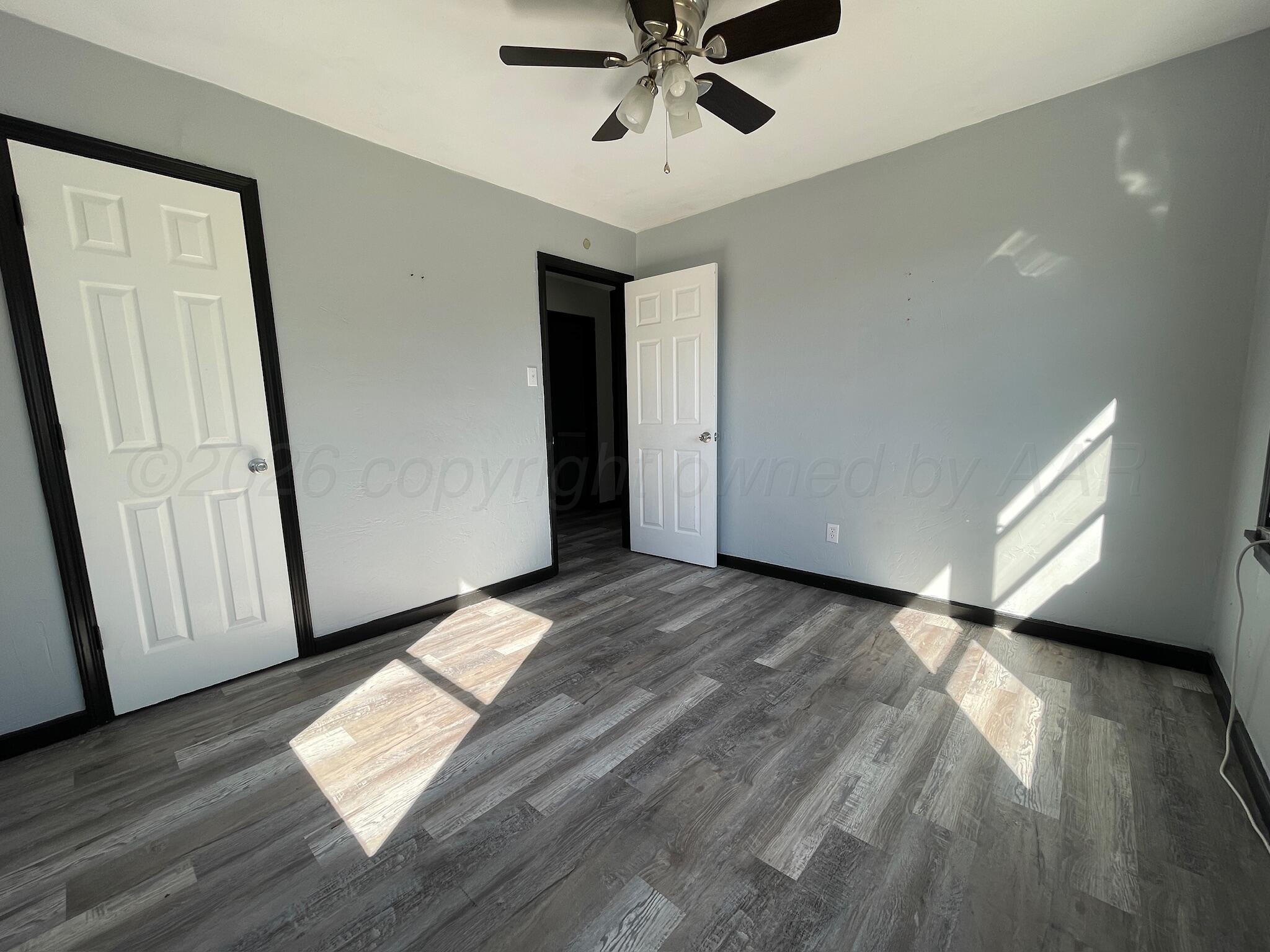 4630 South Ong Street Amarillo, TX 79110 - Photo 7 of 7 a view of an empty room and wooden floor