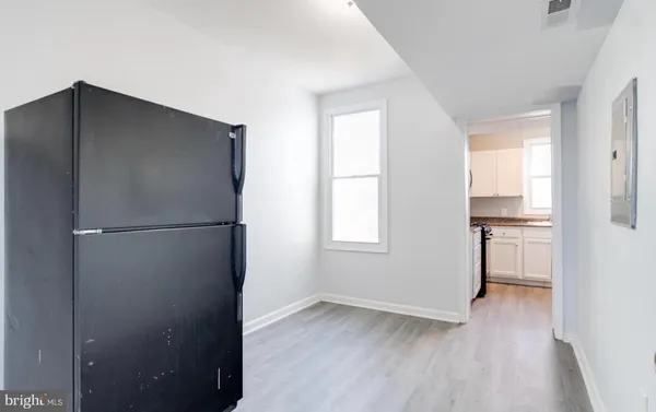 a view of a kitchen with a refrigerator and a stove top oven