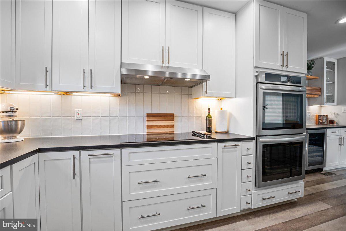 1755 Lottie Fowler Road Prince Frederick, MD 20678 - Photo 14 of 76 a kitchen with granite countertop white cabinets and stainless steel appliances