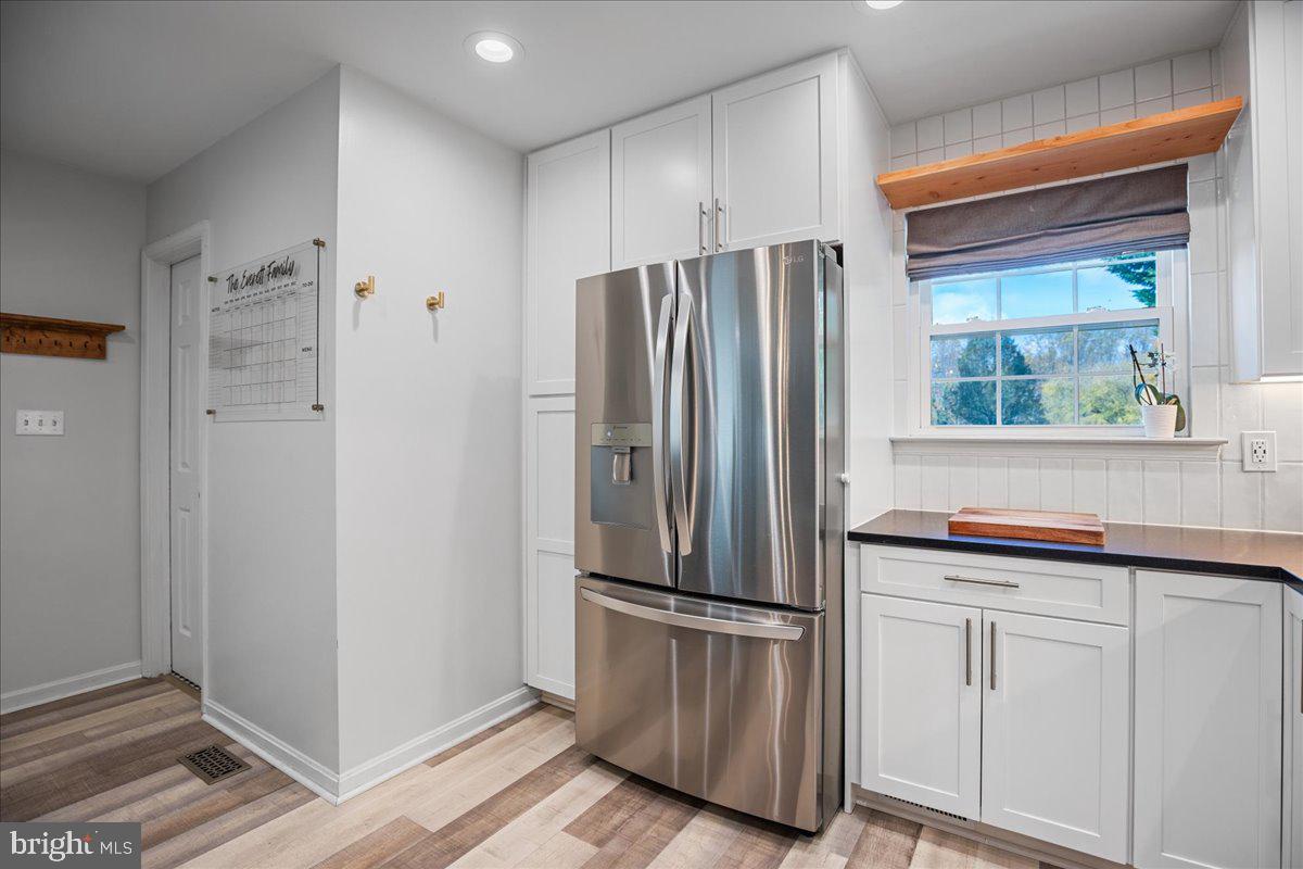 1755 Lottie Fowler Road Prince Frederick, MD 20678 - Photo 16 of 76 a kitchen with cabinets and stainless steel appliances