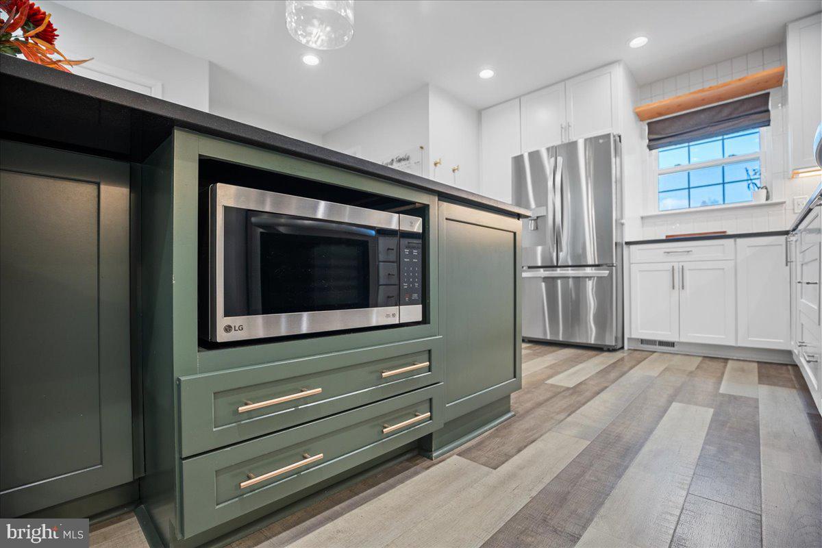 1755 Lottie Fowler Road Prince Frederick, MD 20678 - Photo 21 of 76 a kitchen with granite countertop a refrigerator and a stove