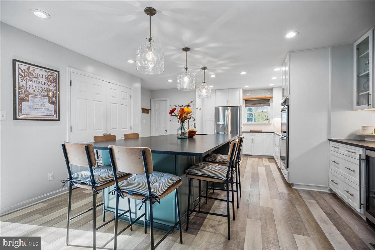 1755 Lottie Fowler Road Prince Frederick, MD 20678 - Photo 25 of 76 a view of a dining room with furniture wooden floor and a chandelier