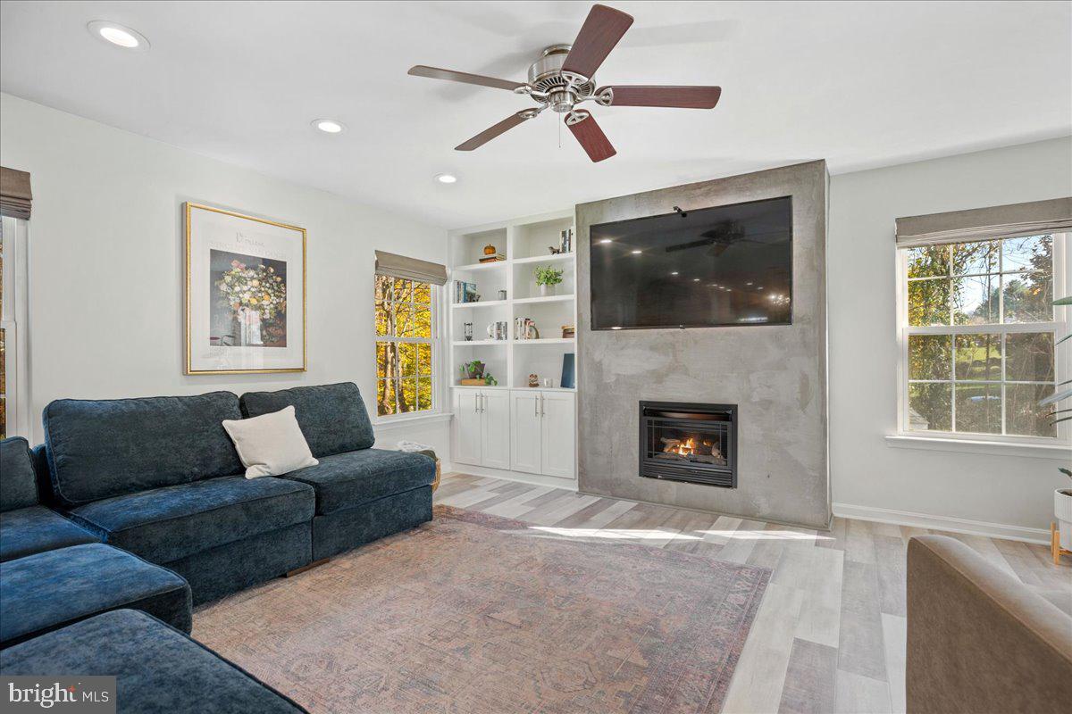 1755 Lottie Fowler Road Prince Frederick, MD 20678 - Photo 33 of 76 a living room with furniture a flat screen tv and a fireplace