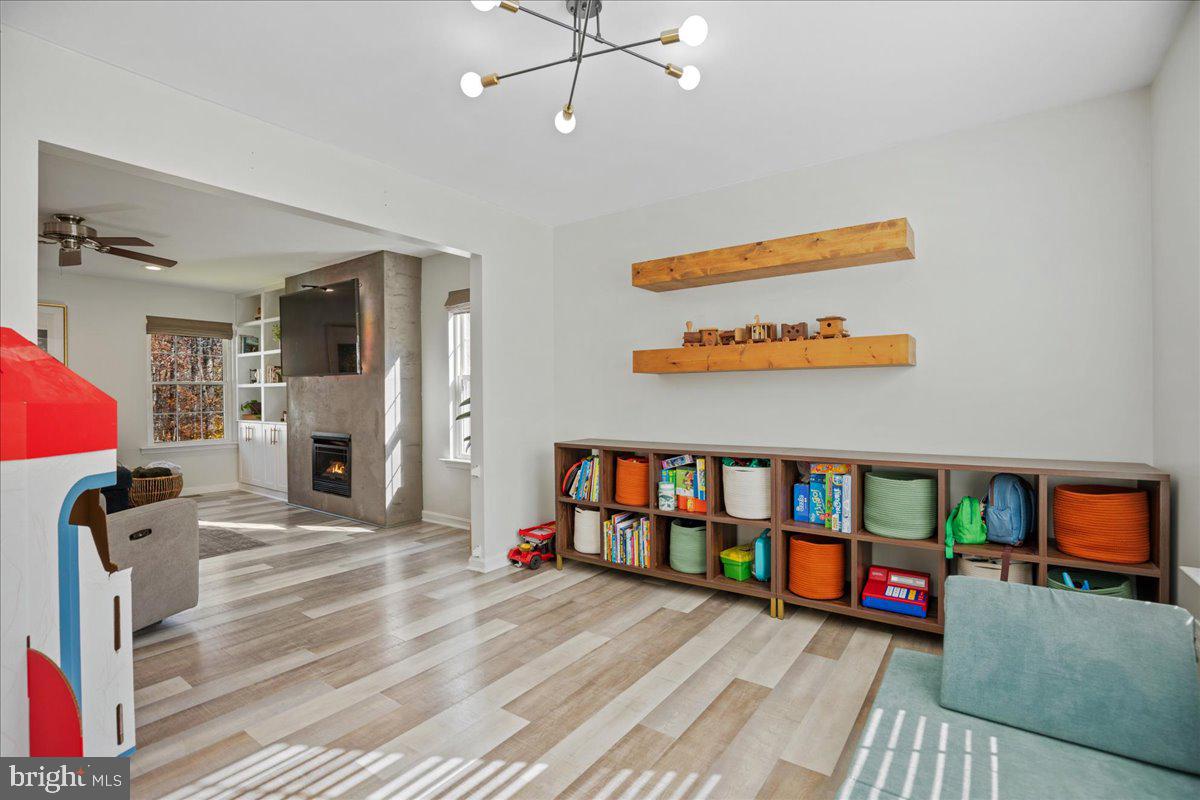 1755 Lottie Fowler Road Prince Frederick, MD 20678 - Photo 37 of 76 a living room with furniture stairs and a flat screen tv