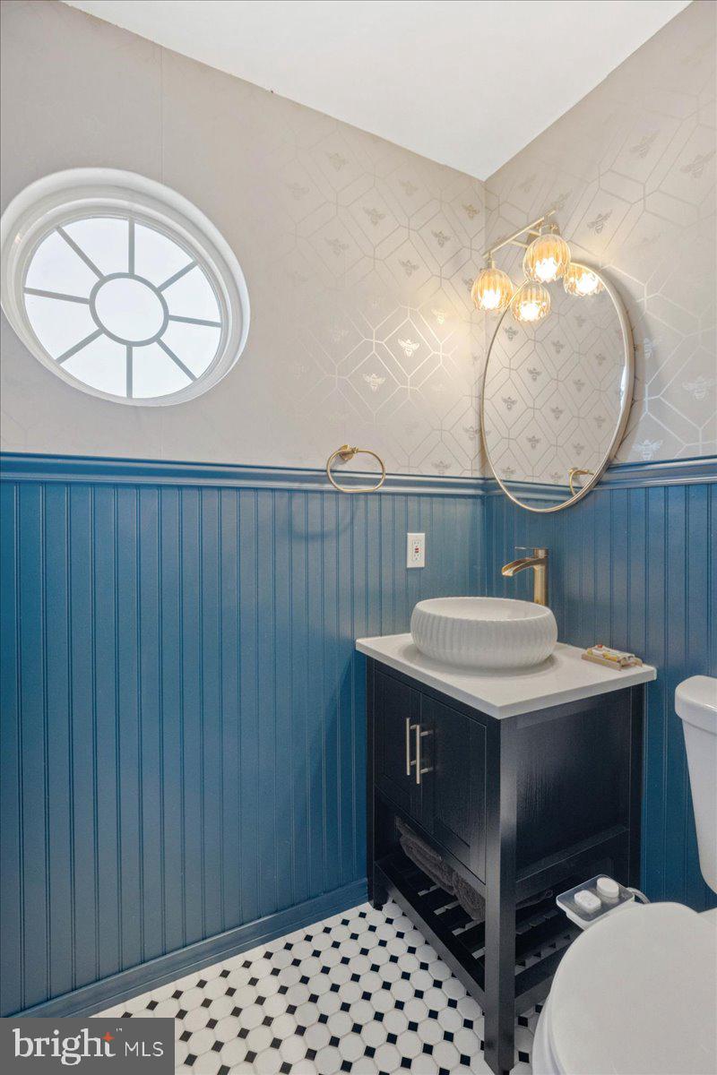 1755 Lottie Fowler Road Prince Frederick, MD 20678 - Photo 39 of 76 a bathroom with a sink a mirror and a toilet