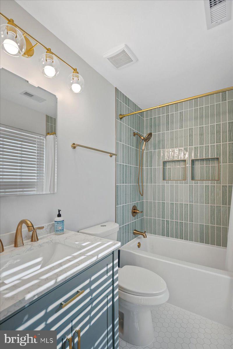 1755 Lottie Fowler Road Prince Frederick, MD 20678 - Photo 44 of 76 a bathroom with a bathtub shower sink vanity mirror and toilet