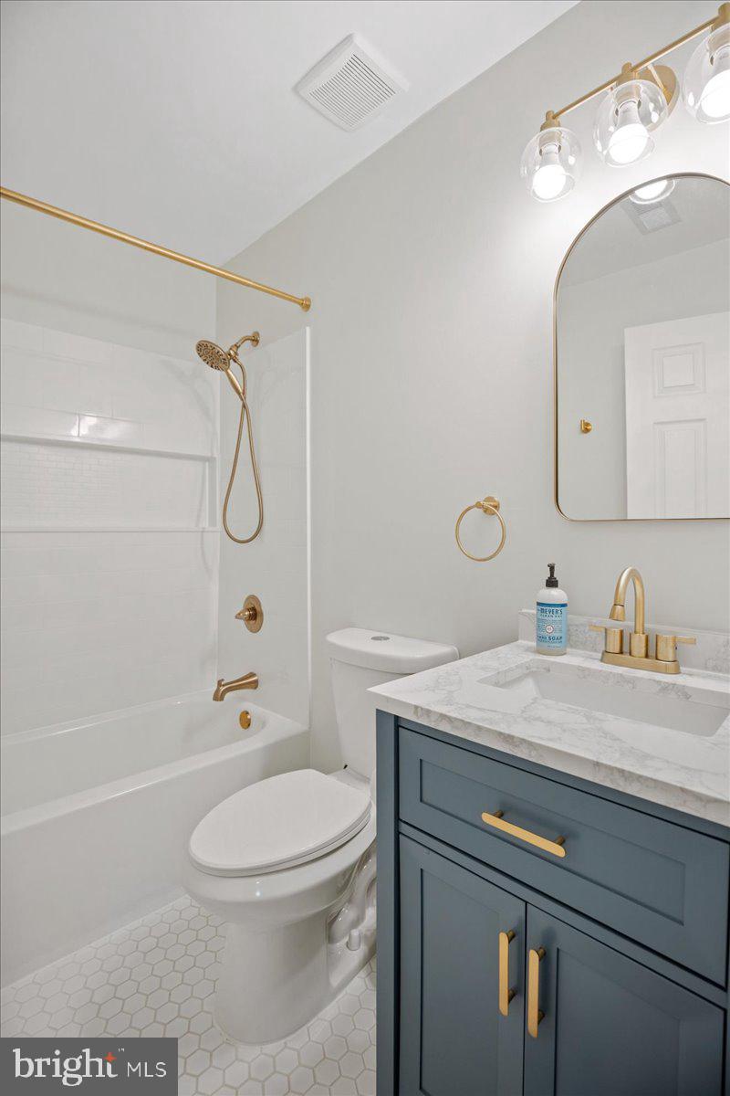 1755 Lottie Fowler Road Prince Frederick, MD 20678 - Photo 49 of 76 a bathroom with a granite countertop sink a toilet and shower
