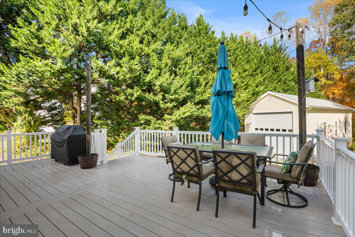 1755 Lottie Fowler Road Prince Frederick, MD 20678 - Photo 62 of 76 a view of a roof deck with table and chairs and wooden floor