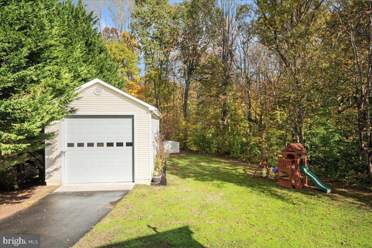 1755 Lottie Fowler Road Prince Frederick, MD 20678 - Photo 63 of 76 a view of a house with a yard and large tree