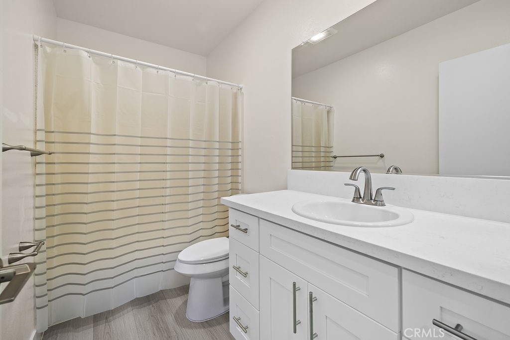 1485 East Wilson Avenue, Unit M Glendale, CA 91206 - Photo 17 of 19 a bathroom with a sink a toilet and mirror