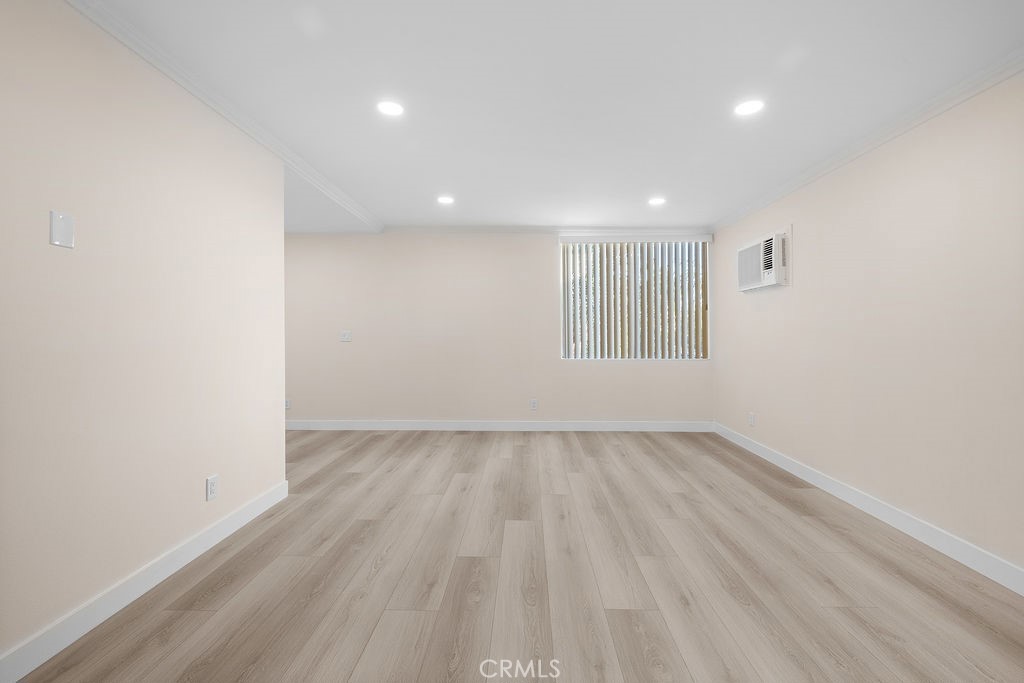 1485 East Wilson Avenue, Unit M Glendale, CA 91206 - Photo 5 of 19 an empty room with wooden floor and windows