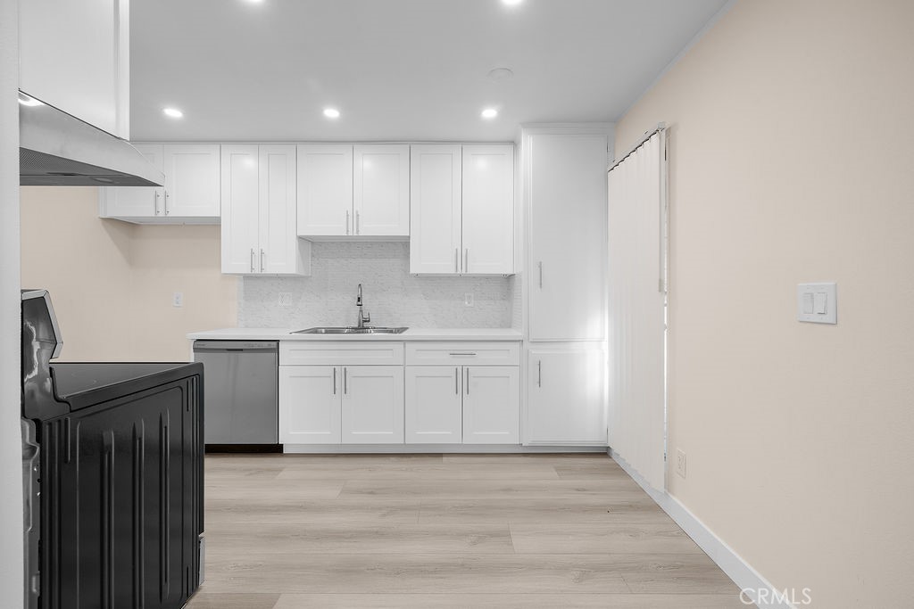 1485 East Wilson Avenue, Unit M Glendale, CA 91206 - Photo 6 of 19 a kitchen with granite countertop white cabinets and stainless steel appliances