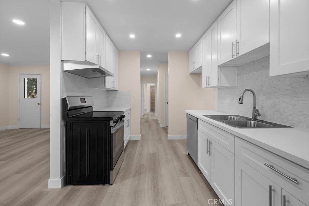 1485 East Wilson Avenue, Unit M Glendale, CA 91206 - Photo 8 of 19 a kitchen with granite countertop a sink and a stove top oven