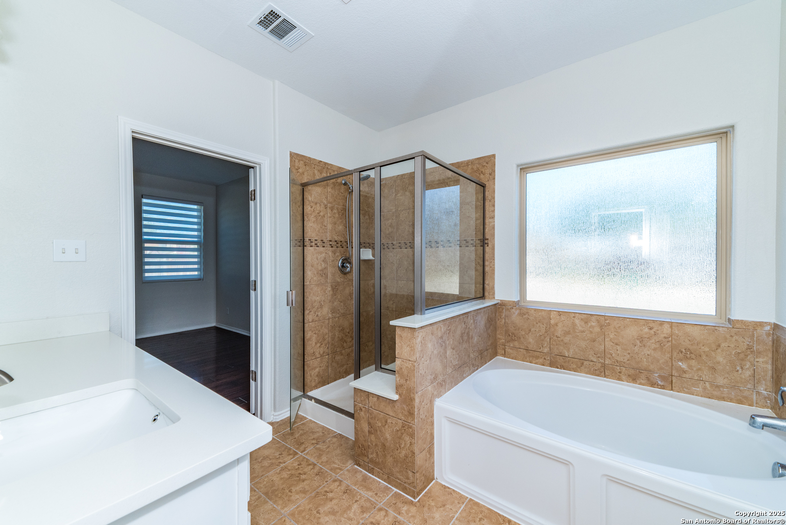 7735 Brisbane Bend Converse, TX 78109 - Photo 8 of 15 a bathroom with a bathtub and a shower