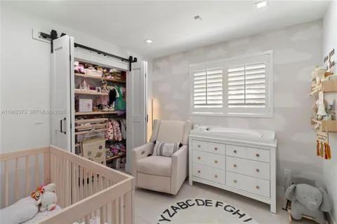 a bedroom with furniture and a window