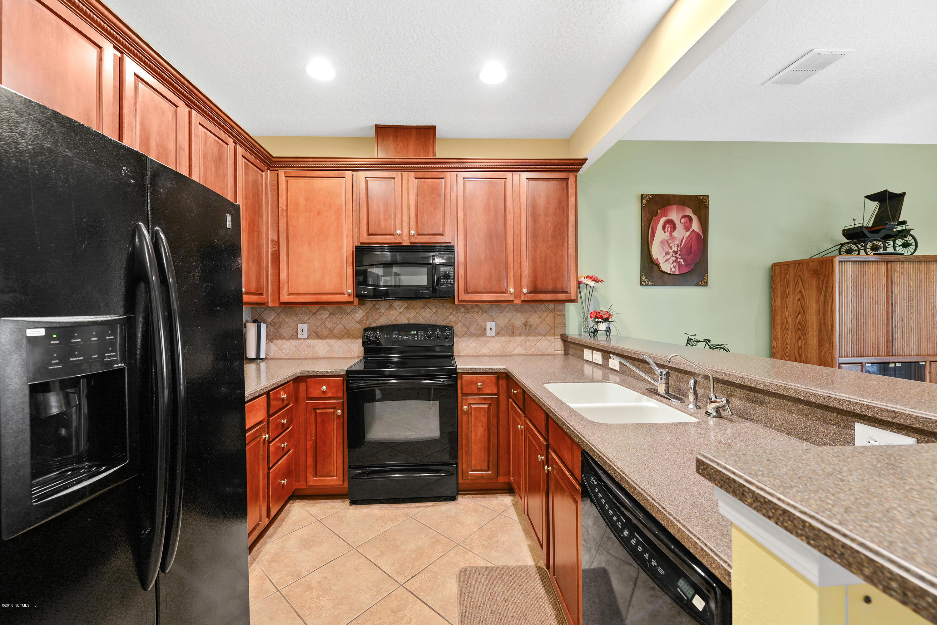 12996 Spring Rain Road Jacksonville, FL 32258 - Photo 3 of 15 a kitchen with stainless steel appliances granite countertop a refrigerator sink and stove
