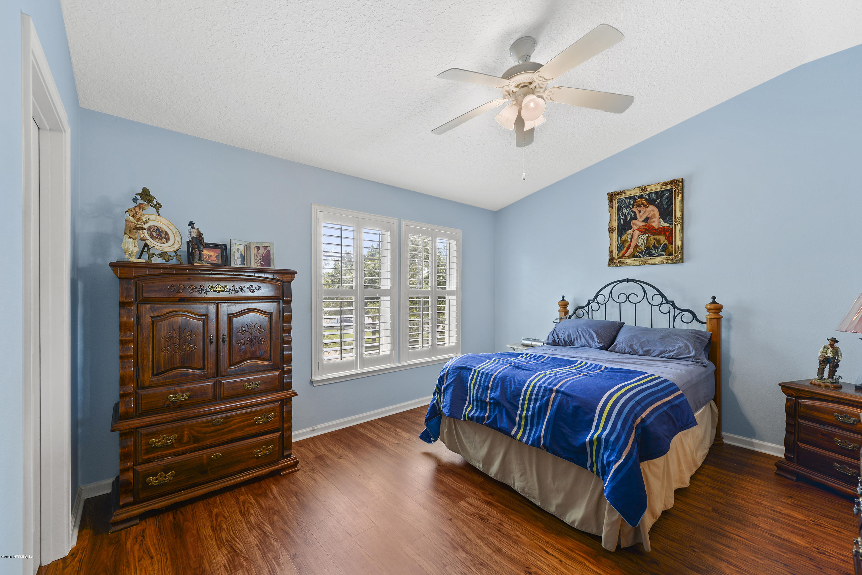 12996 Spring Rain Road Jacksonville, FL 32258 - Photo 7 of 15 a bedroom with a bed and a chandelier