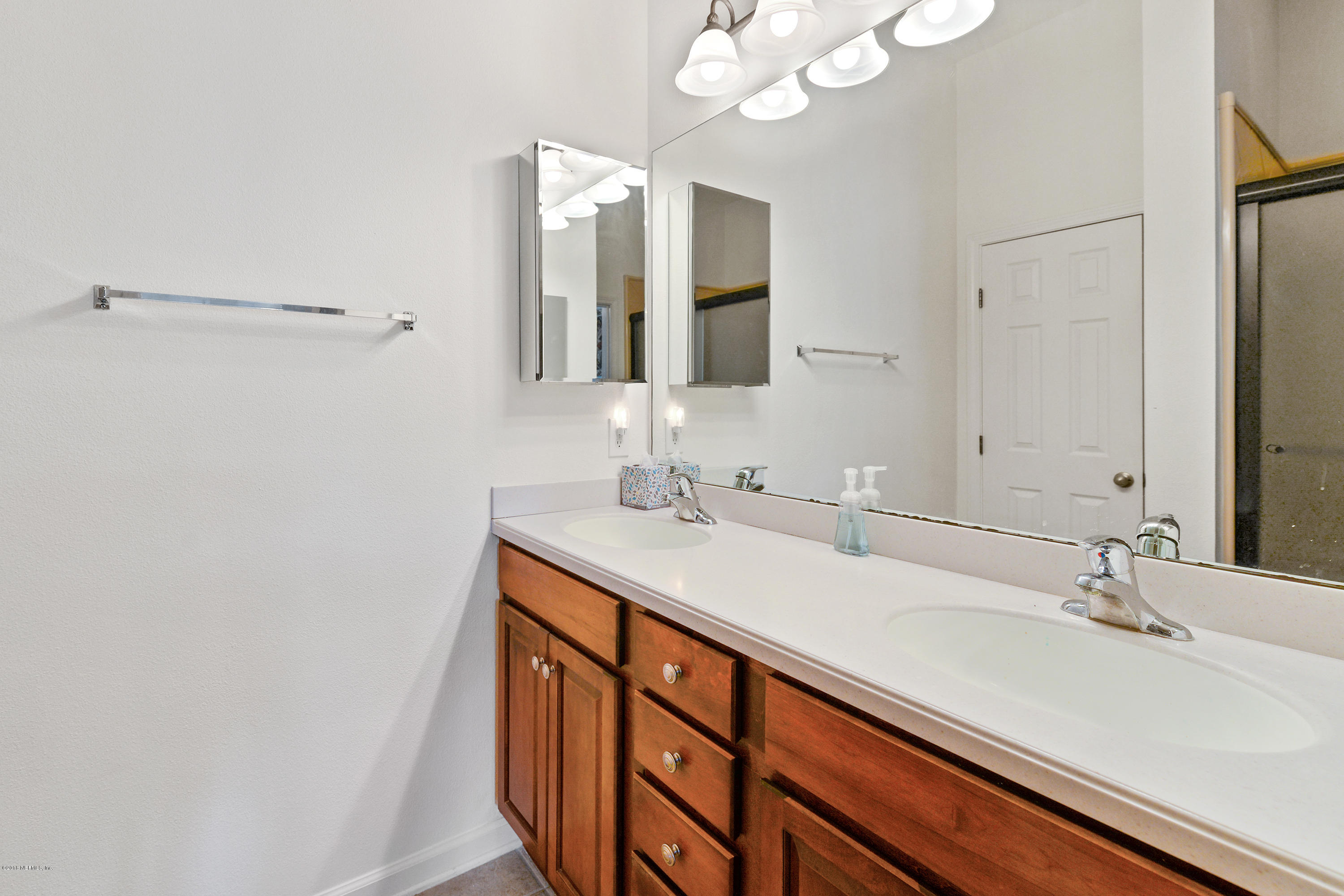 12996 Spring Rain Road Jacksonville, FL 32258 - Photo 8 of 15 a bathroom with a sink double vanity and a mirror