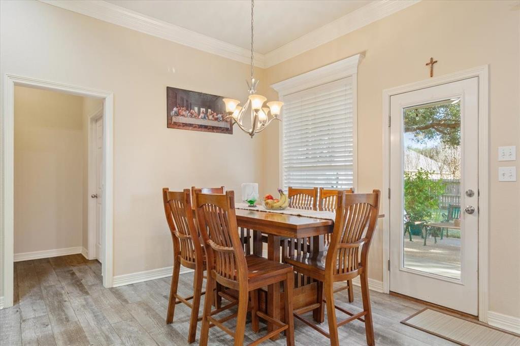 5620 Landsdown Drive Waco, TX 76708 - Photo 11 of 37 a dining room with furniture a chandelier and wooden floor