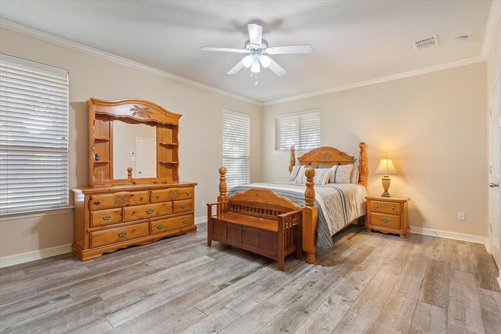5620 Landsdown Drive Waco, TX 76708 - Photo 16 of 37 a bedroom with a bed and a dresser