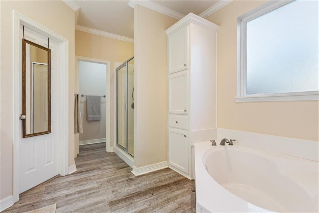 5620 Landsdown Drive Waco, TX 76708 - Photo 18 of 37 a bathroom with a bathtub and a shower